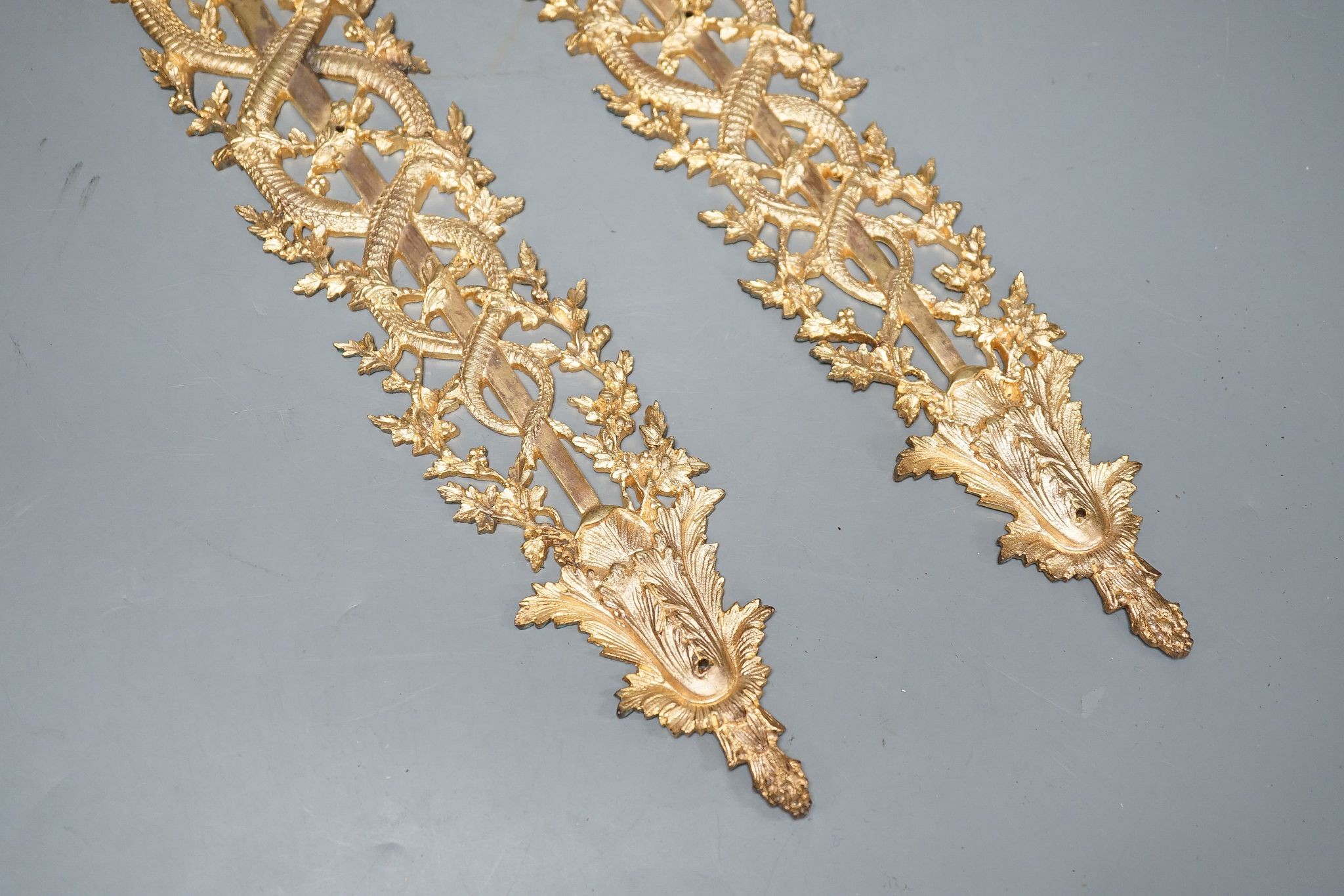 A pair of ormolu furniture mounts, circa 1900, 48cm long